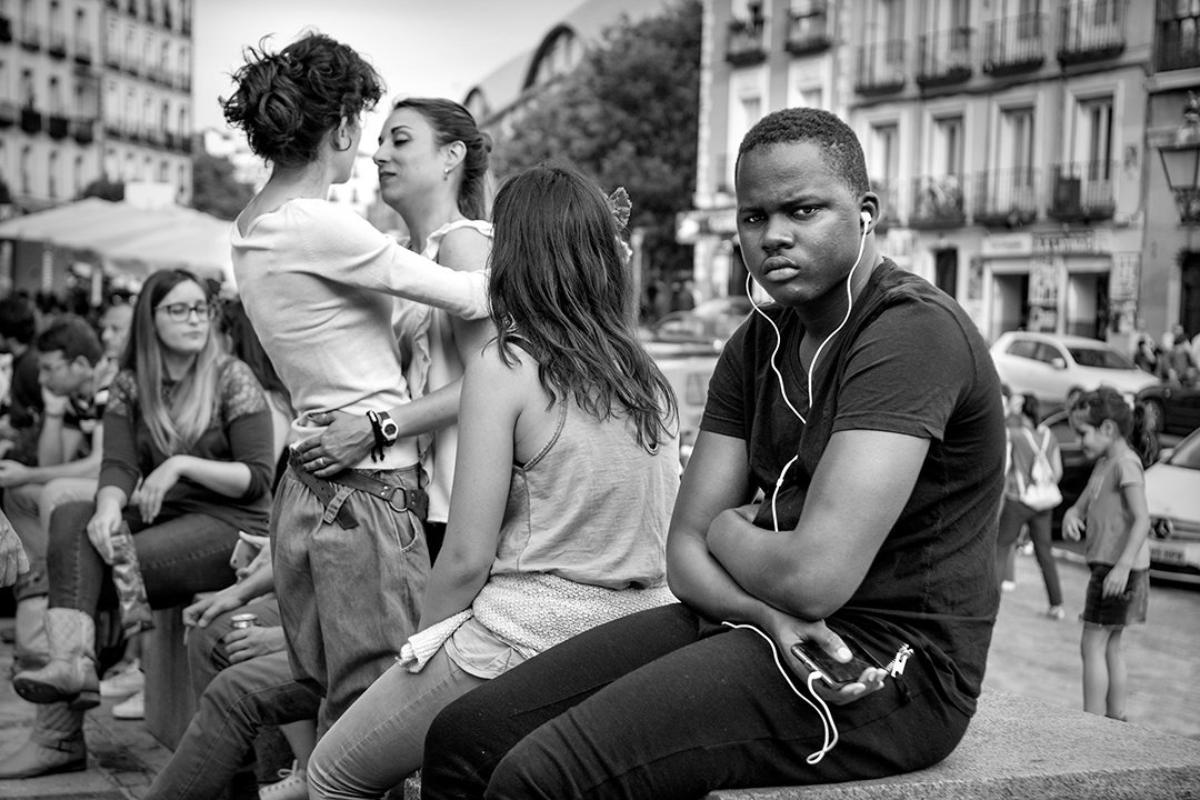 People talking while seated in a square.